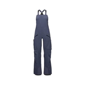 “Vista frontal del peto de mujer Black Diamond Factor en color charcoal, mostrando su diseño técnico, tirantes y bolsillos con cremallera impermeable.”